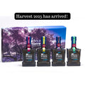 Finca La Torre Harvest 2025 Selection Gift Set featuring four premium extra virgin olive oils in dark glass bottles with colorful labels, displayed in front of a scenic olive grove box.