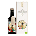 A bottle of Nobleza del Sur extra virgin olive oil with a label featuring a bee and floral design, accompanied by its packaging box.
